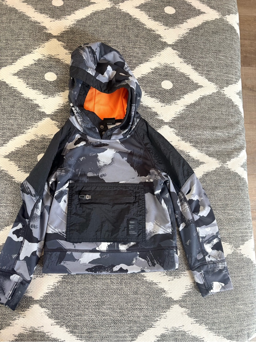 Next Level Apparel Kids Camo Pullover Rain Jacket with Orange Hood Lining